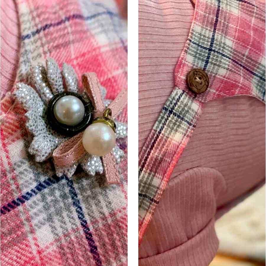 Close up of brooch pendant and wooden button on the back of the Pretty in Pink Dog Romper and Turtleneck from online posh puppy boutique they made me wear it.