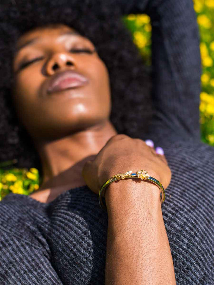 Black woman wearing the beautiful Sunflower Memorial Bracelet in Stainless Steel from online boutique they made me wear it. The perfect gift to hold ashes of your loved ones and cherish their memory. Free engraving.