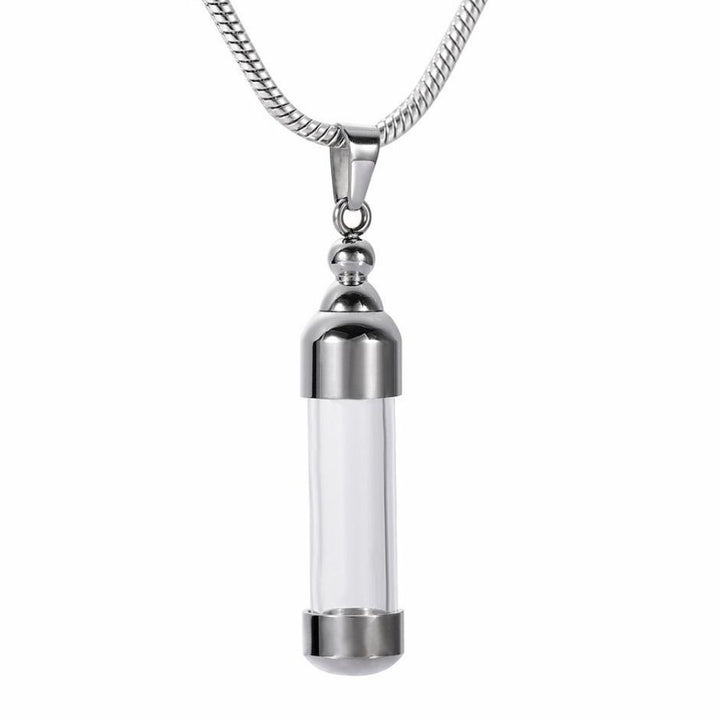 Delicate Silver Capsule Cremation Necklace to memorialize your loved ones forever. Personalized bereavement gifts for family and friends who want a vial to hold a small amount of ashes to remember the loved ones they've lost. Free engraving available from online store they made me wear it.