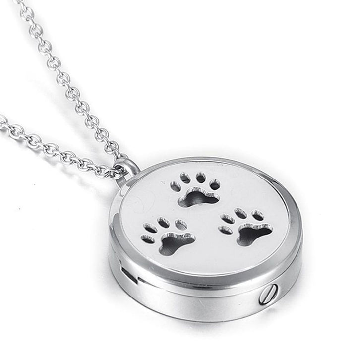 Beautiful Silver Paw Print Memorial Locket is the perfect bereavement gift for family and friends who want a cremation locket to hold a small amount of pet ashes to remember their dog who crossed over the rainbow bridge. The locket can also be used as an aromatherapy essential oil diffuser as it comes with 12 free felt pads. Available from online boutique store they made me wear it.