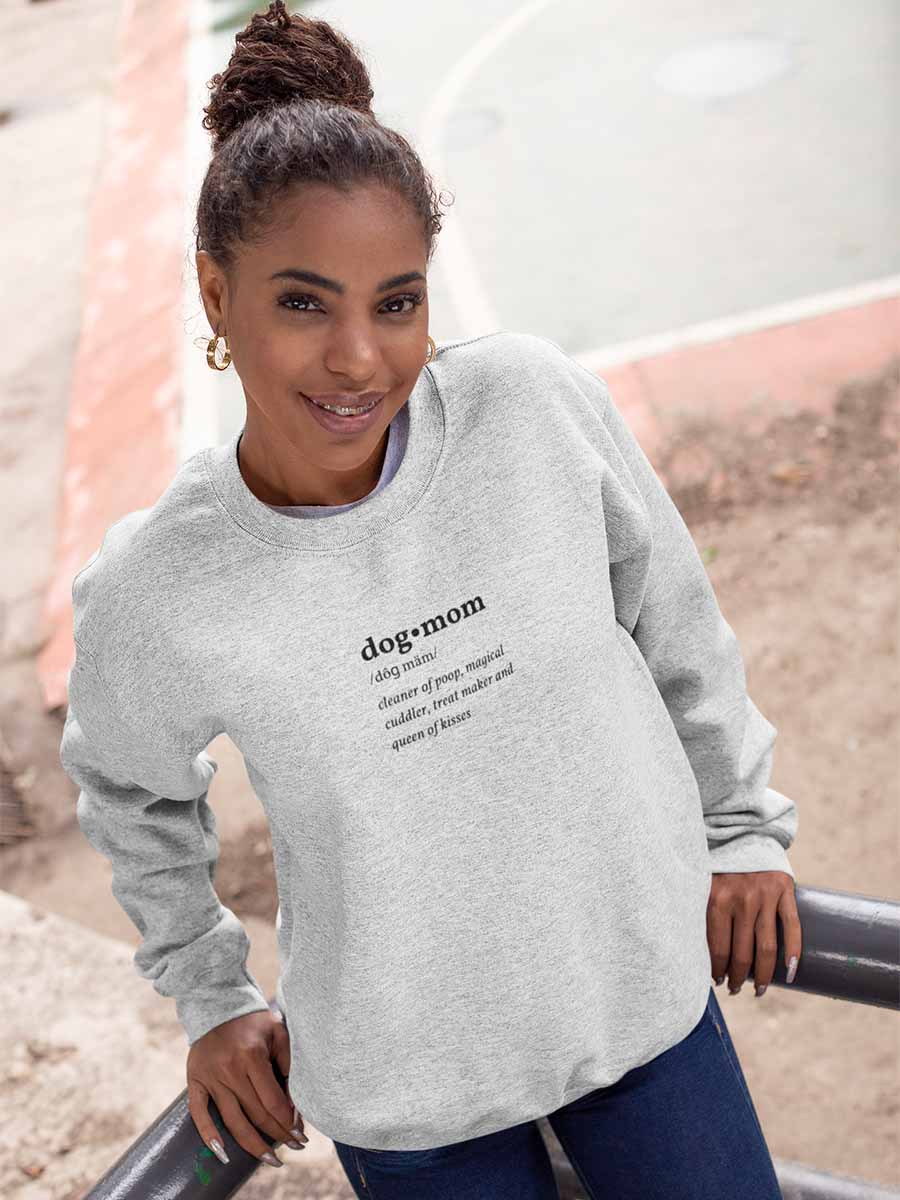 Woman leaning against the rail wearing the Oatmeal Dog Mom Defined Crewneck Sweatshirt from online outerwear and activewear clothing store for pet parents, they made me wear it.